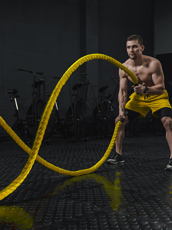 young athlete doing battle ropes exercise